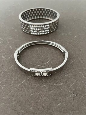 2 Silver tone Cuff Bracelets - one missing stone.